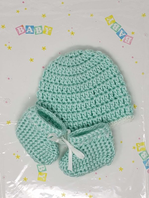 Green newborn booties and hat set